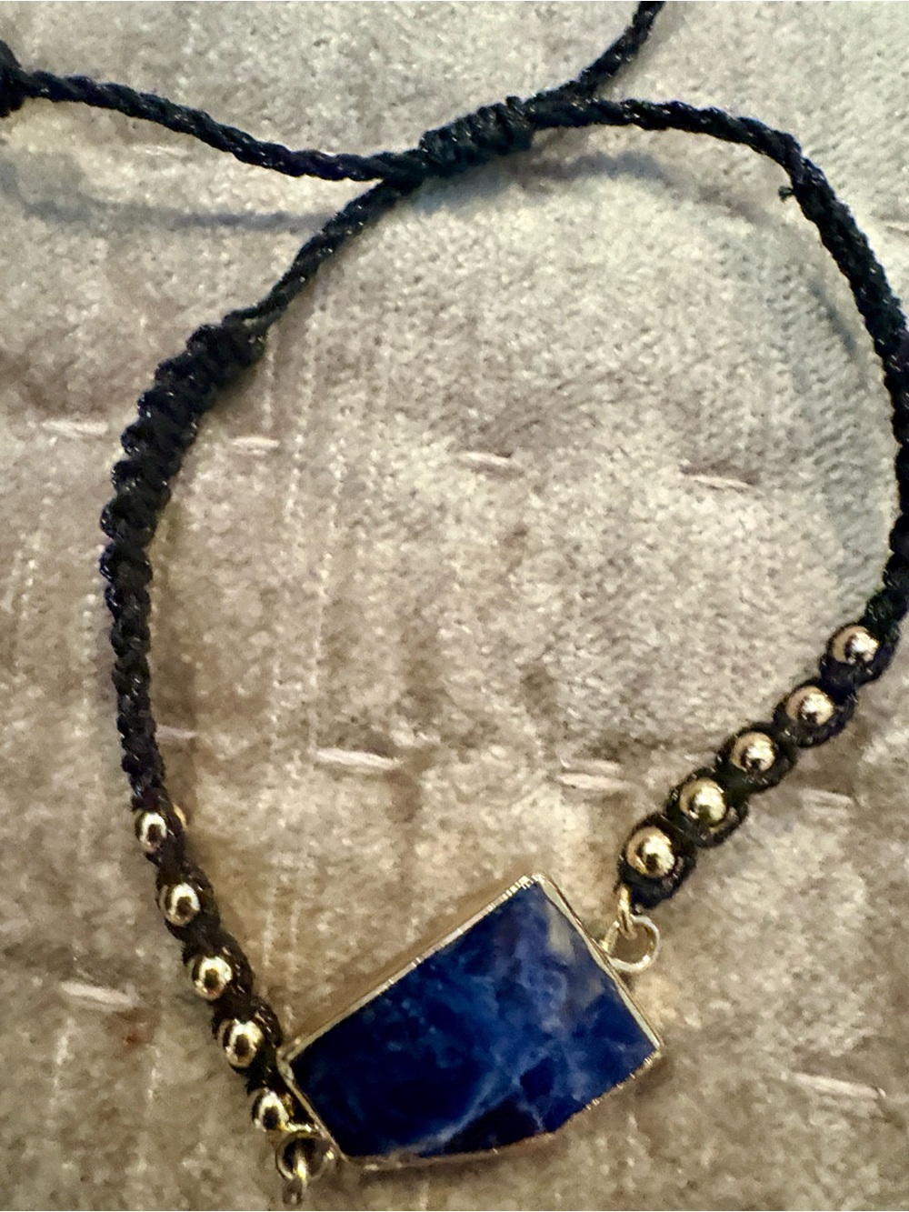 Bracelet (adjustable) blue stone look and black beaded cord with tassels